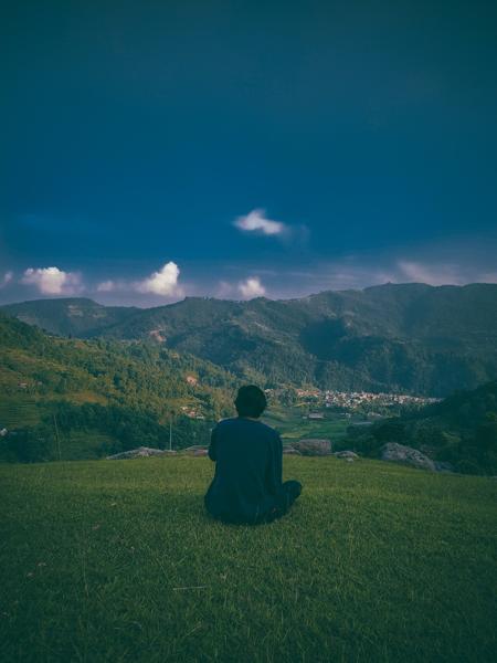 An image of a young boy sitting looking at the nature beauty-banrupi
