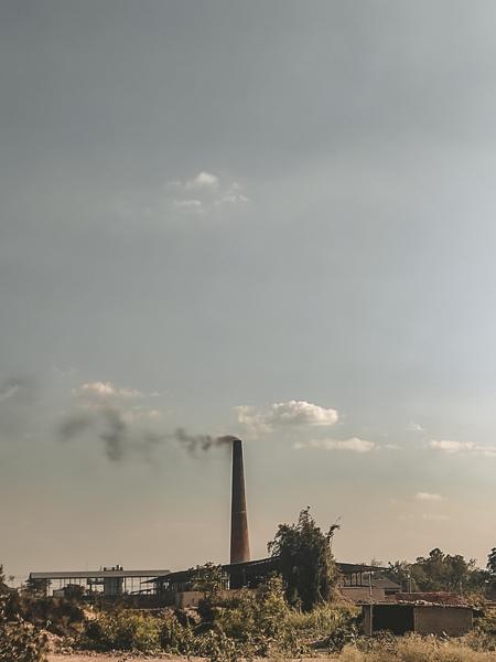 An image of an industry smoking coming from chimney-banurpi
